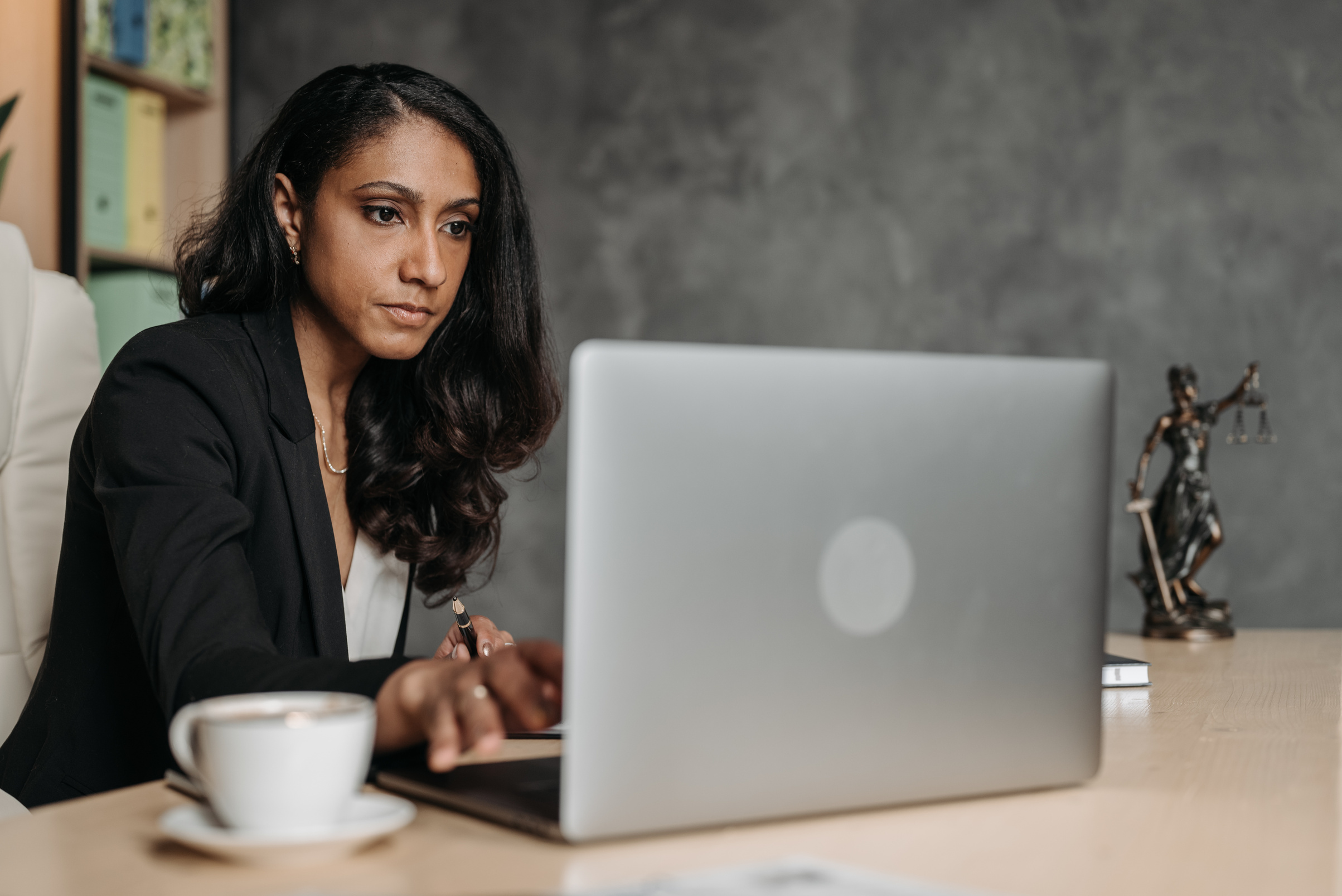 Woman in Black Blazer Using Macbook